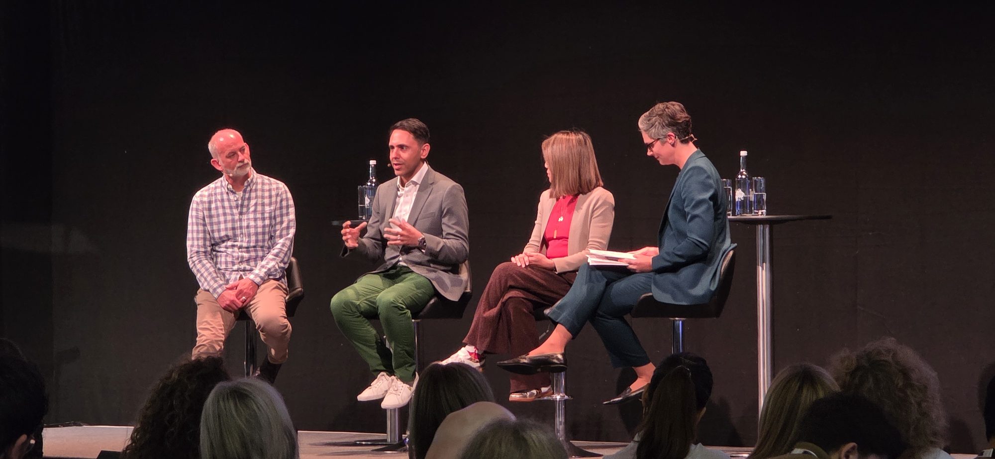 Rahim Hirji speaking on a four-person panel on the main stage at the CIPD Festival of Work in London, with the audience in the foreground