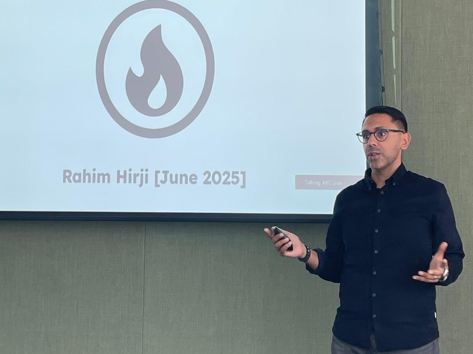 Rahim Hirji presenting in front of a screen reading The SuperSkills Era: Thriving in the Age of AI