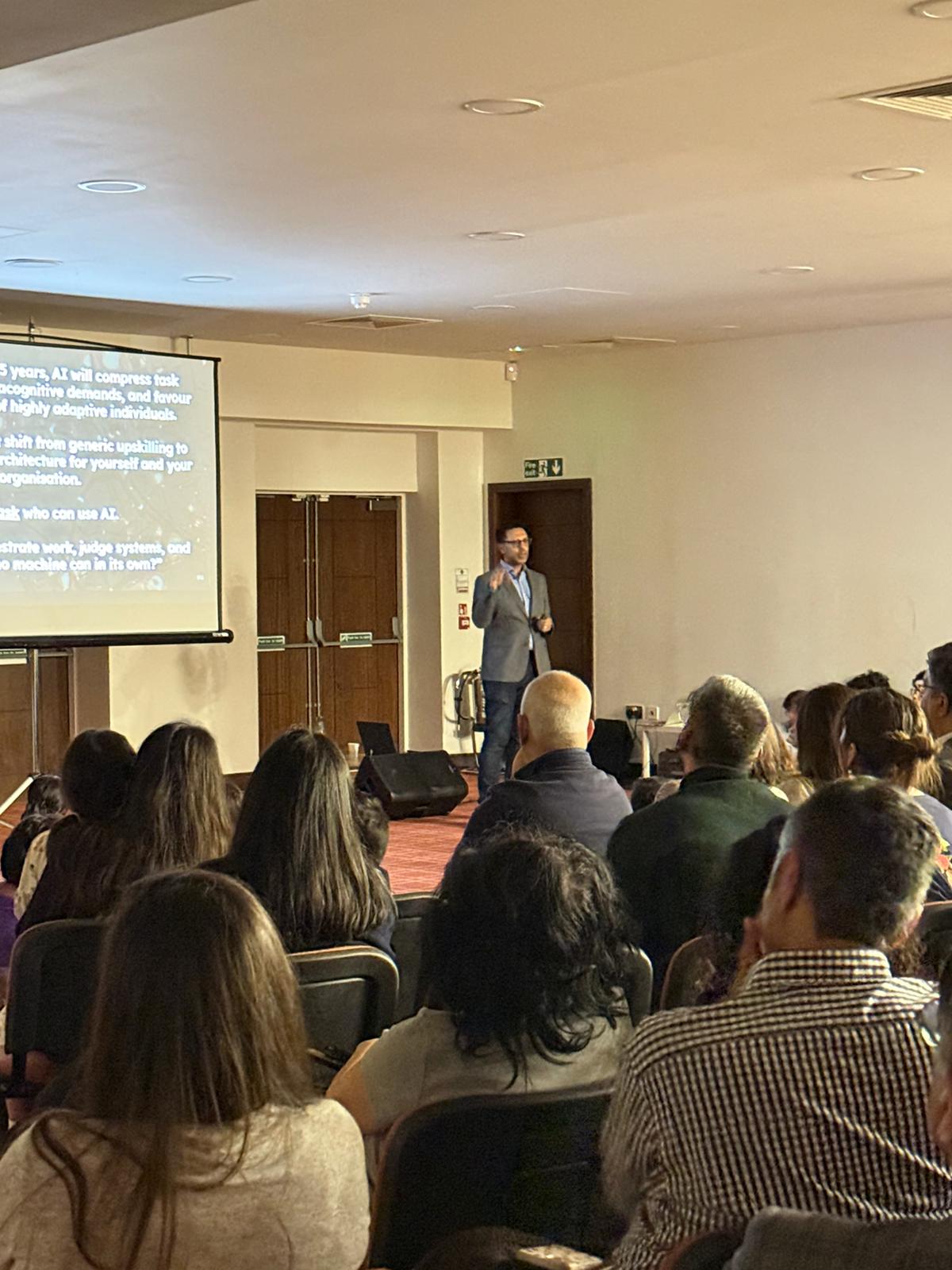 Rahim Hirji speaking at a 500-person education session