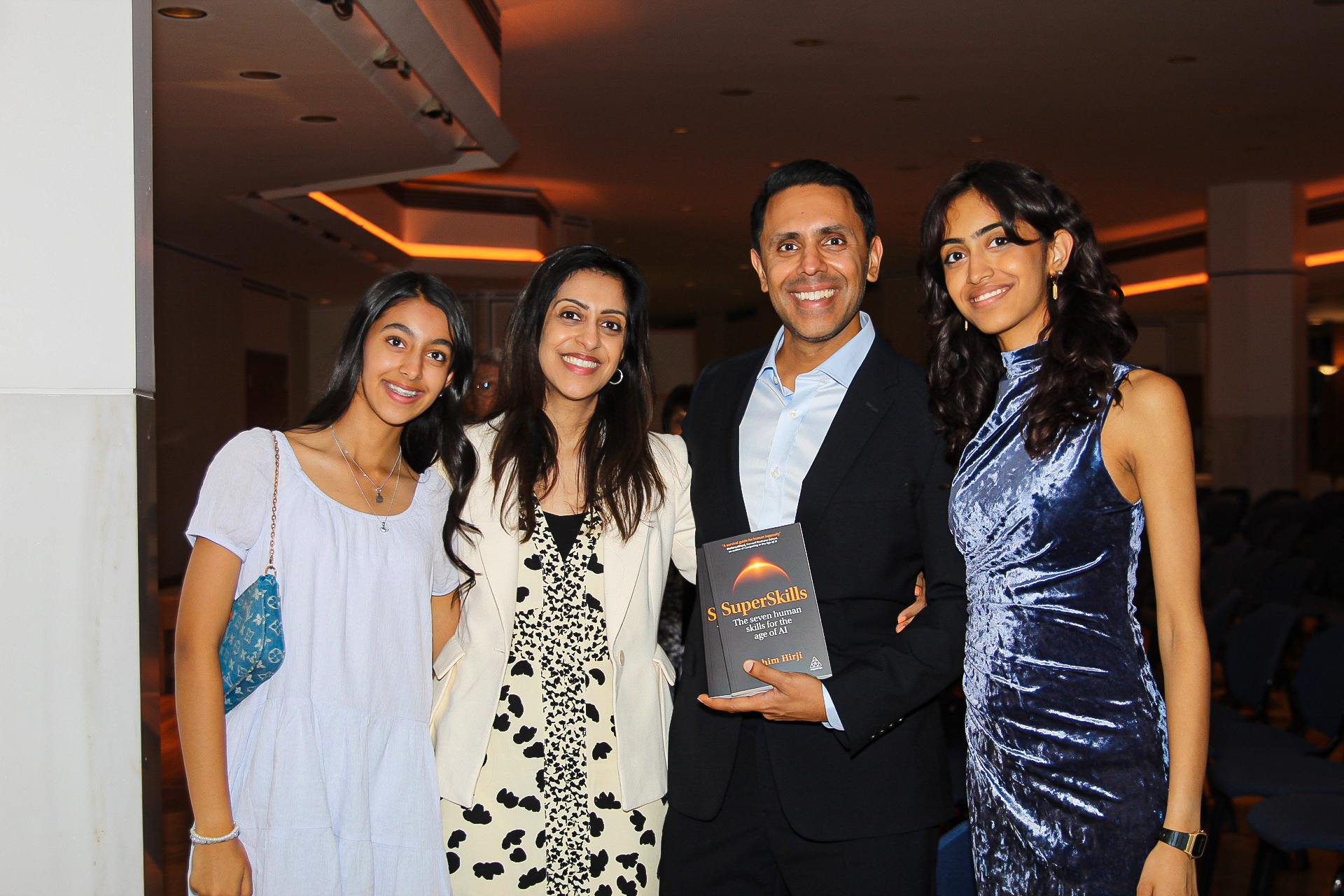 Rahim Hirji with his wife and daughters holding SuperSkills