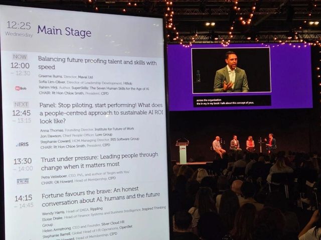 Rahim Hirji on the main stage at a large conference